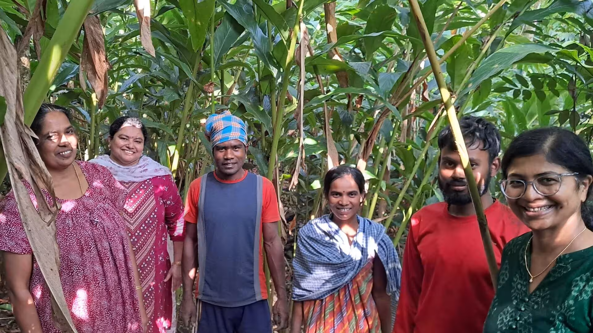 Group photo with company founders and farm owners and workers