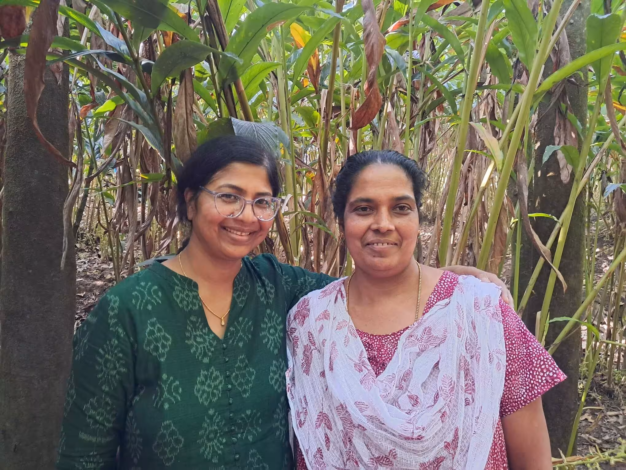 Photo of Gardenia Whispers founder on the left and farmer partner on the right.
